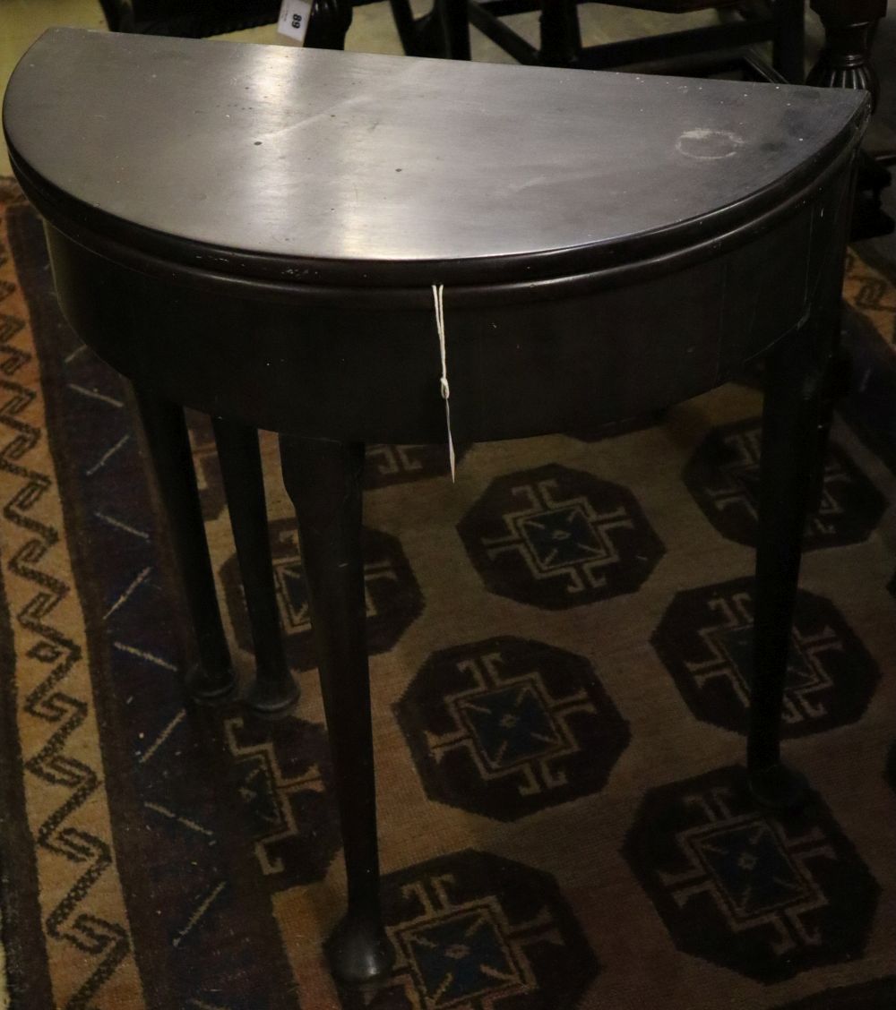 A George III D shaped mahogany folding tea table, width 68cm depth 33cm height 73cm